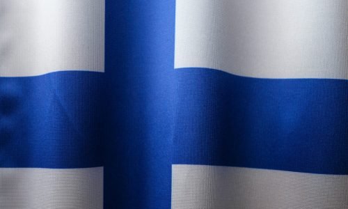 Detailed close-up of the Finnish flag showcasing its blue cross on white fabric.