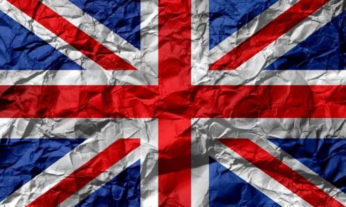 Crumpled texture of the Union Jack flag, symbolizing UK unity and heritage.